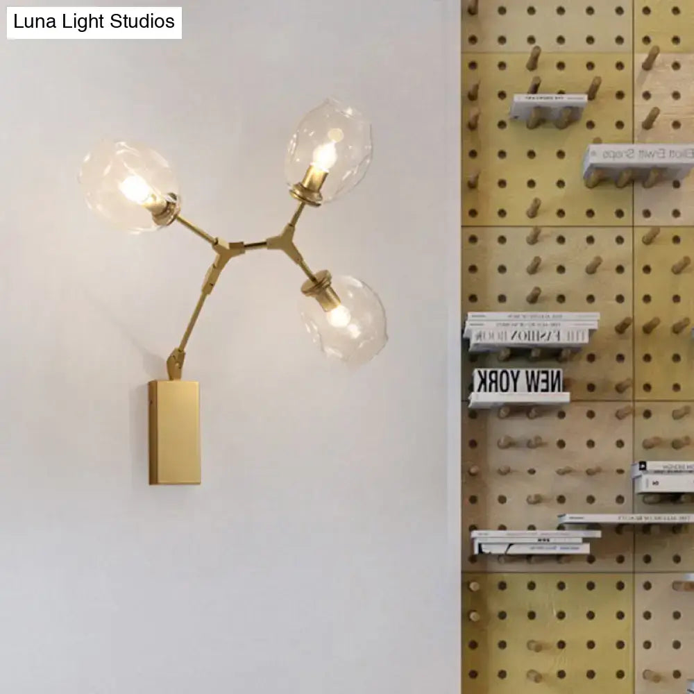 Modern gold branch wall lamp with three clear glass globe shades and rectangular base for living room lighting
