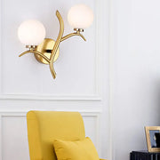 Modern gold branch wall light fixture with two frosted glass globes and organic design for living room sconce