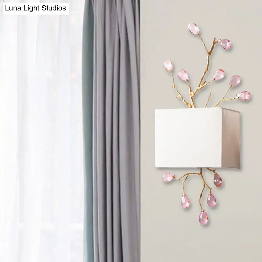 Modern gold branch wall sconce with white fabric shade and pink crystal accent for elegant bedroom lighting