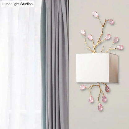 Modern gold branch wall sconce with white fabric shade and pink crystal accent for elegant bedroom lighting