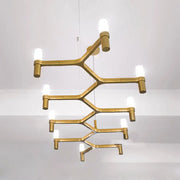 Gold-toned metallic branch island pendant light with frosted glass bulbs for modern dining room lighting
