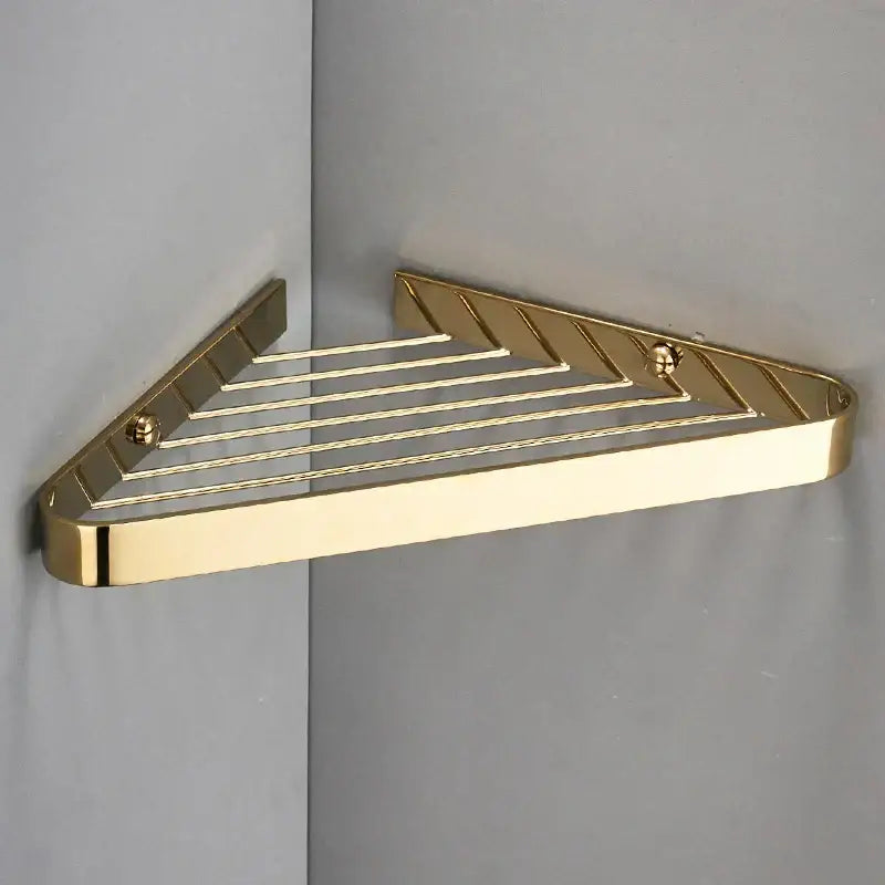 Modern gold brass bathroom shower rack with hooks featuring a sleek triangular corner shelf and polished metal finish