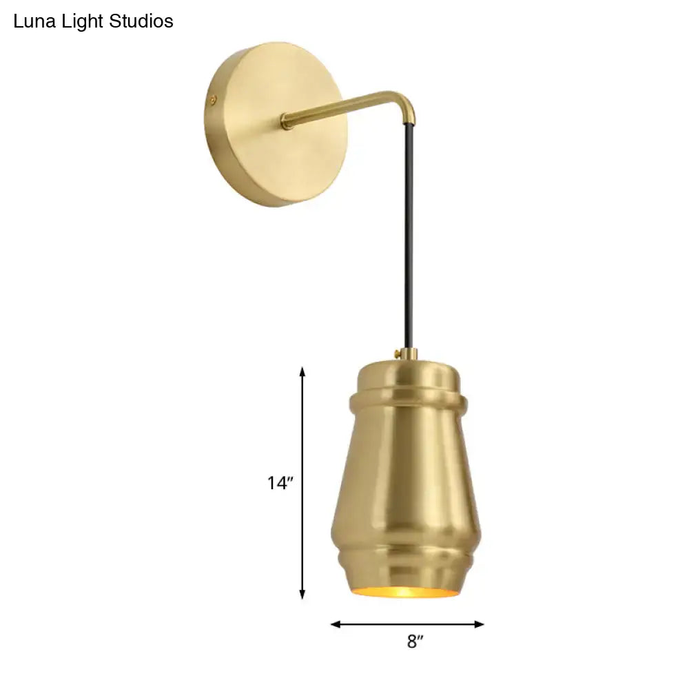 Modern gold brass bedroom wall sconce with metal shade fixture and sleek tapered cylindrical shade and black cord