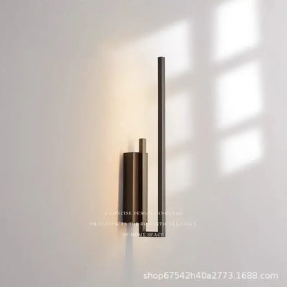 Modern gold brass wall light sconce with three vertical brushed bronze bars and frosted glass emitting warm ambient light