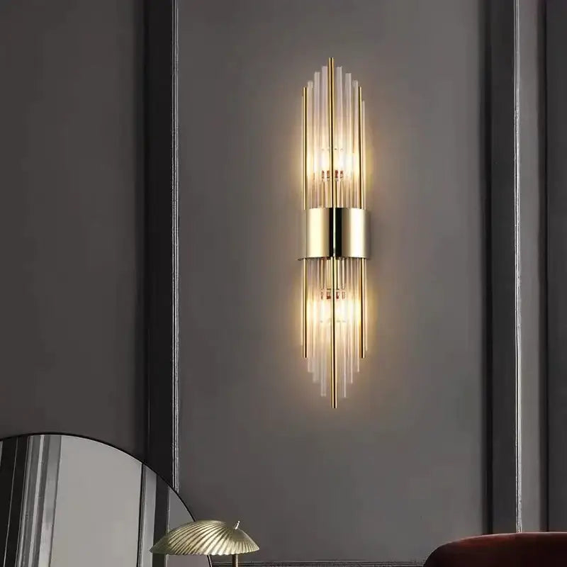 Modern gold and brushed steel wall lamp with vertical glass rods and central cylindrical fixture for living room decorbites gold led