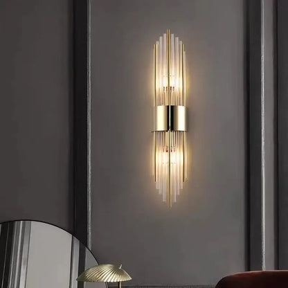 Modern gold and brushed steel wall lamp with vertical glass rods and central cylindrical fixture for living room decorbites gold led