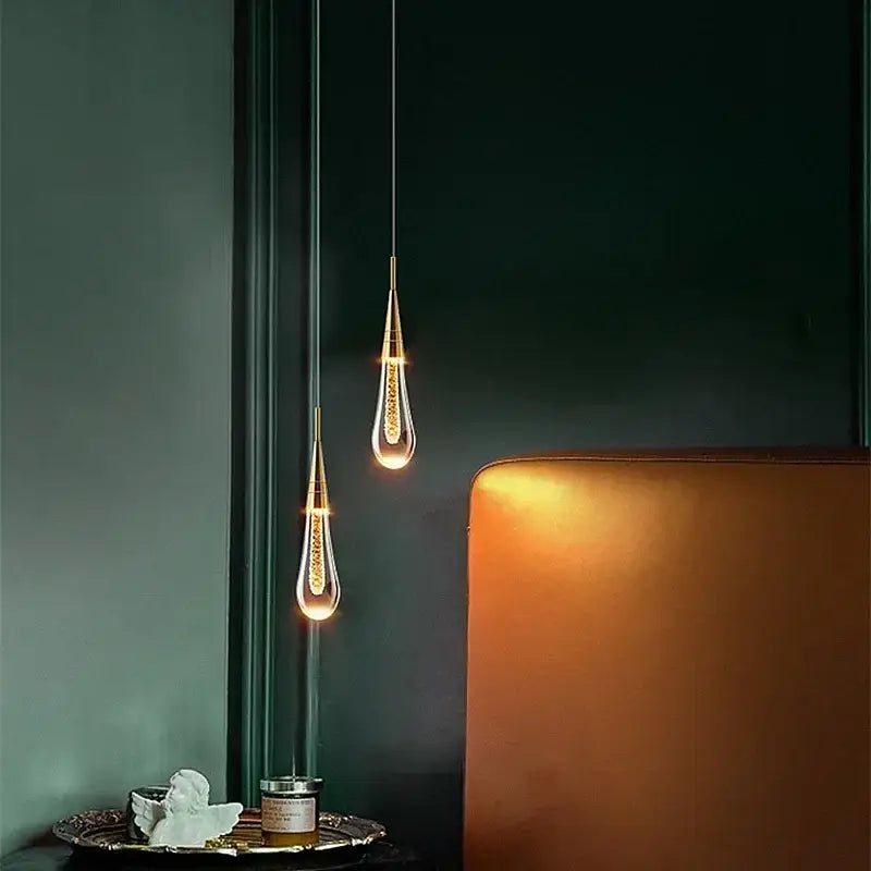 Two elegant gold-toned decorbites bubble crystal pendant lights with teardrop glass shades for dining room decor