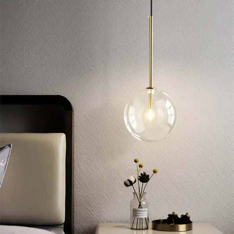 Modern gold bubble glass ball pendant light with clear glass globe and slender gold-toned rod for kitchen decorbites bubble glass