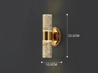 Modern gold bubble glass vanity lights featuring a gold-toned sconce with clear glass and two horizontal brass bands by decorbites gold vanity