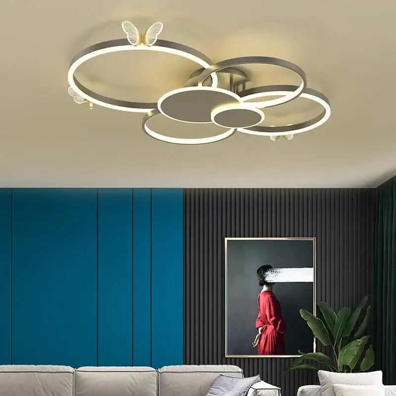 Modern gold butterflies ceiling light with interconnected circular rings and metallic finish for luxury bedroom decorbites ceiling