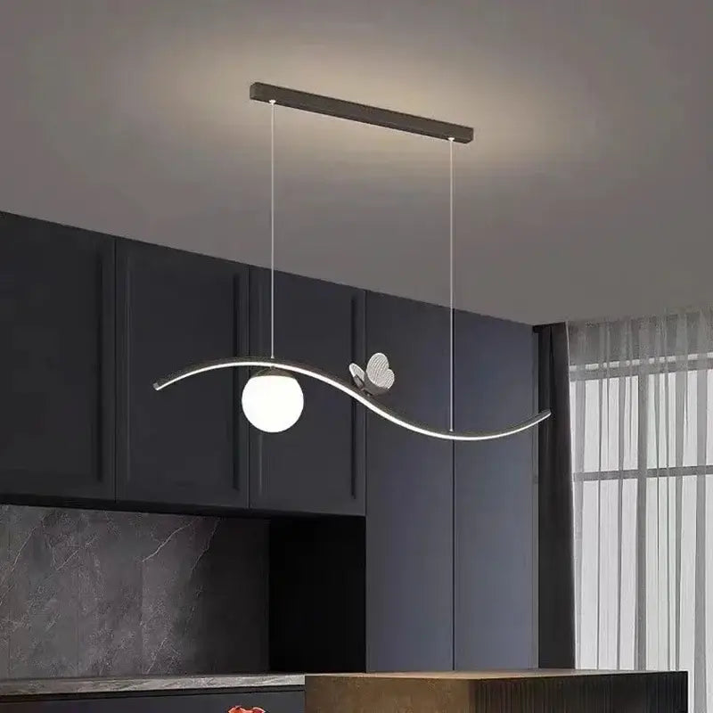 Modern gold decorbites butterfly chandelier pendant light with sleek curved metallic frame and spherical white glass bulb