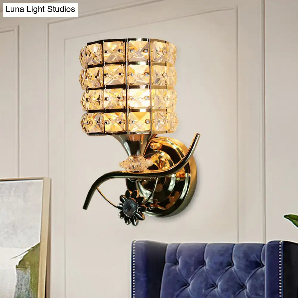 Modern gold butterfly wall light fixture with a tiered crystal shade and ornate floral accent for living room use