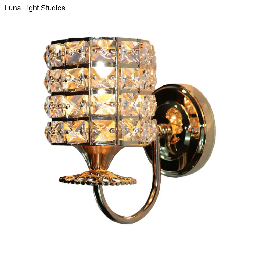 Modern gold butterfly wall light fixture with a cylindrical crystal shade for elegant living room lighting