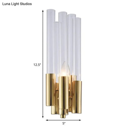 Modern gold candelabra sconce with flute crystal shade and brushed brass base featuring five clear glass tubes and exposed bulb