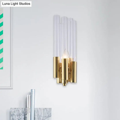 Modern gold candelabra sconce with five clear acrylic flute crystal shade tubes on polished gold metal base for bedroom light