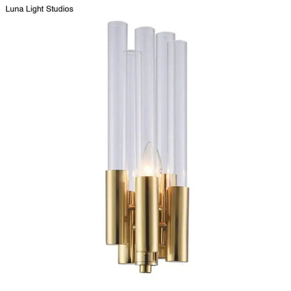 Modern gold candelabra sconce with flute crystal shade featuring five clear acrylic tubes on a polished brass base