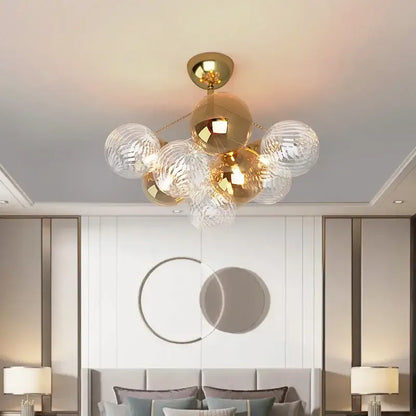 Modern gold cartoon bubble ball chandelier featuring gold-toned spherical glass orbs with polished brass finish for kids room decorbites cartoon bubble