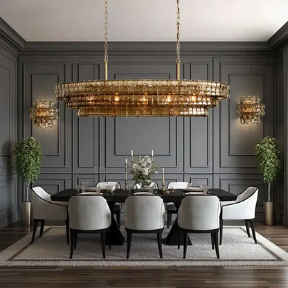 A modern gold multi-tiered cascading pendant light with decorbites brown glass pendant for dining room decor