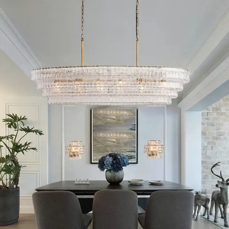 Modern gold cascading crystal pendant lights with clear glass prisms and gold-toned chains for dining room decorbites brown glass