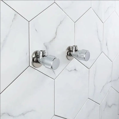 Two sleek chrome brass triangle valve bathroom faucets mounted on white marble hexagonal tiles by decorbites brass