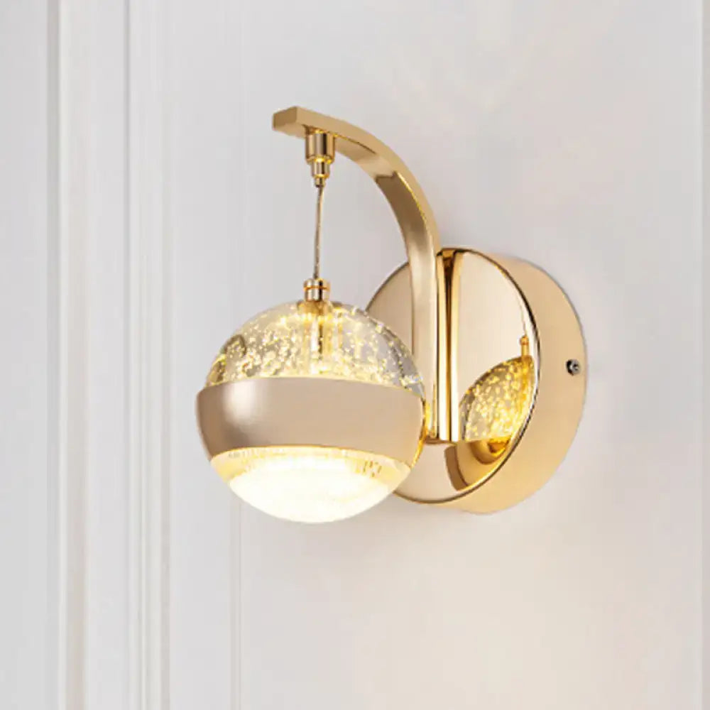 Modern gold chrome wall light with crystal ball featuring crackled glass globe and warm glowing light for bedroom lighting