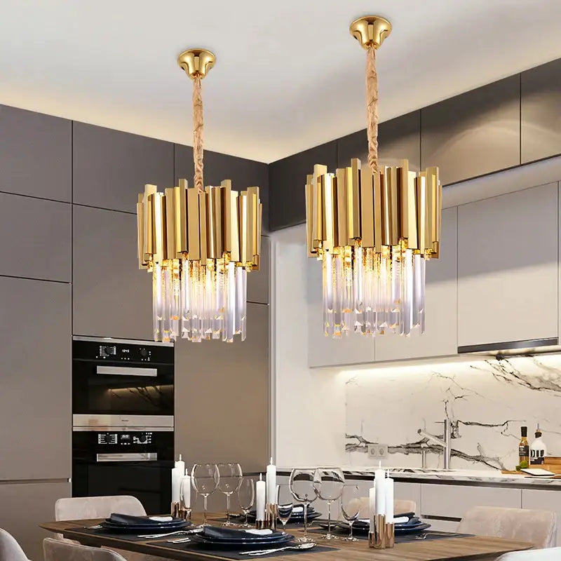 Two modern gold and chrome decorbites crystal pendant chandeliers with vertical bars and hanging crystal droplets for dining room