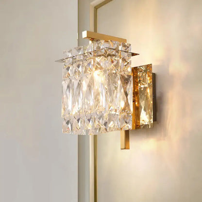 Modern gold and chrome crystal wall light fixture with faceted clear crystals and e12 e14 bulb base emitting warm light