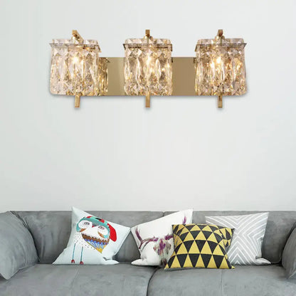 Modern gold and chrome wall light fixture with three crystal encased e12 e14 bulbs and elegant fixture width design