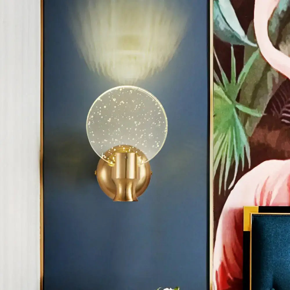 Modern gold circle panel wall light with direct wired electric design and translucent glass shade featuring bubble crystal