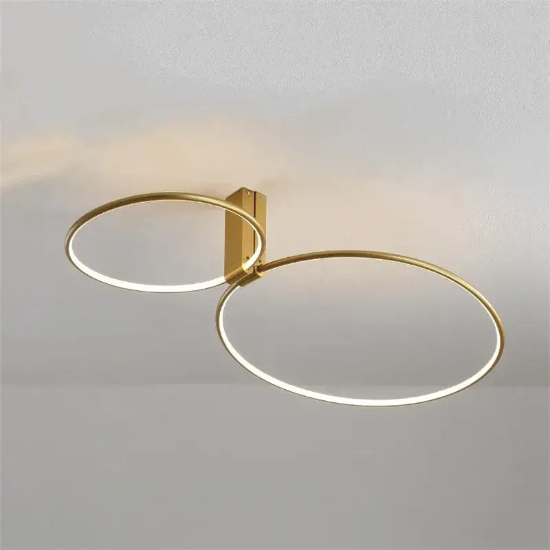 Modern gold circular led ceiling light with two interlocking rings and 360 degree rotation by decorbites circular led