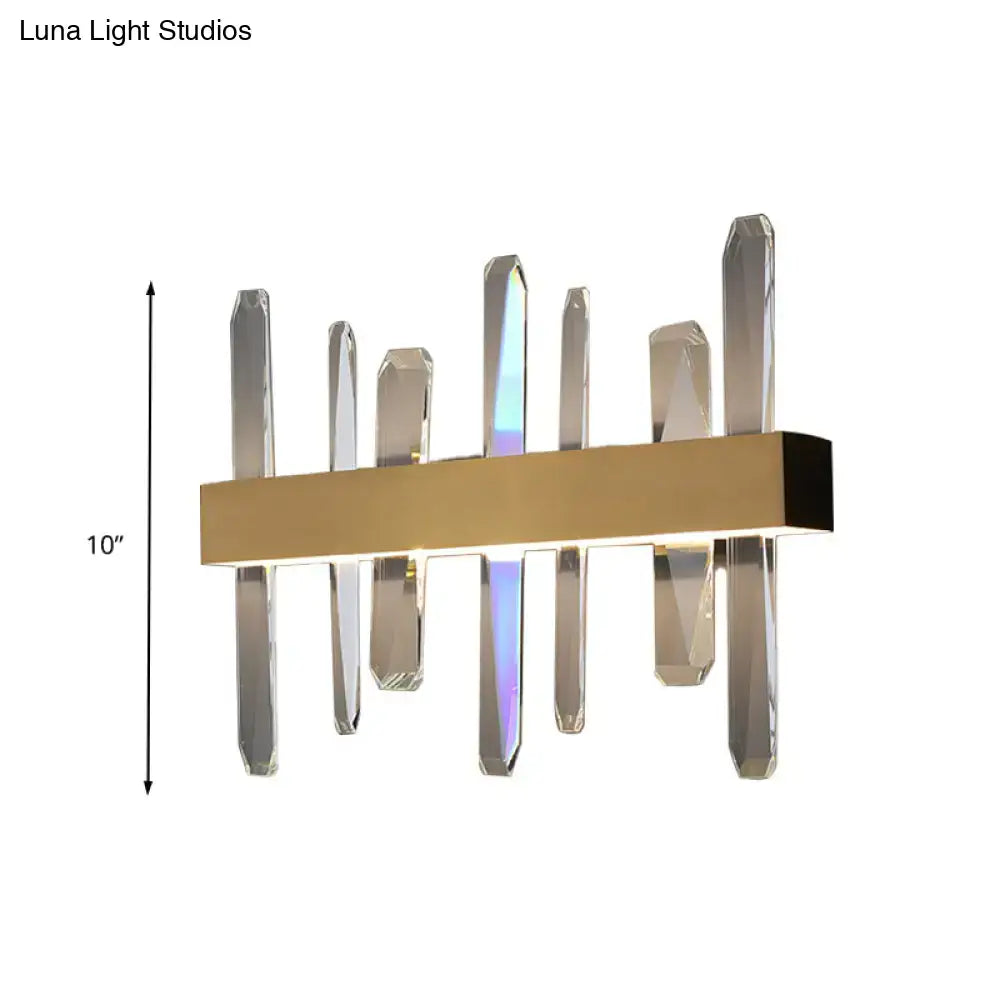 Modern gold clear crystal bar wall sconce with sleek rectangular base and vertical clear crystal prisms refracting colorful light