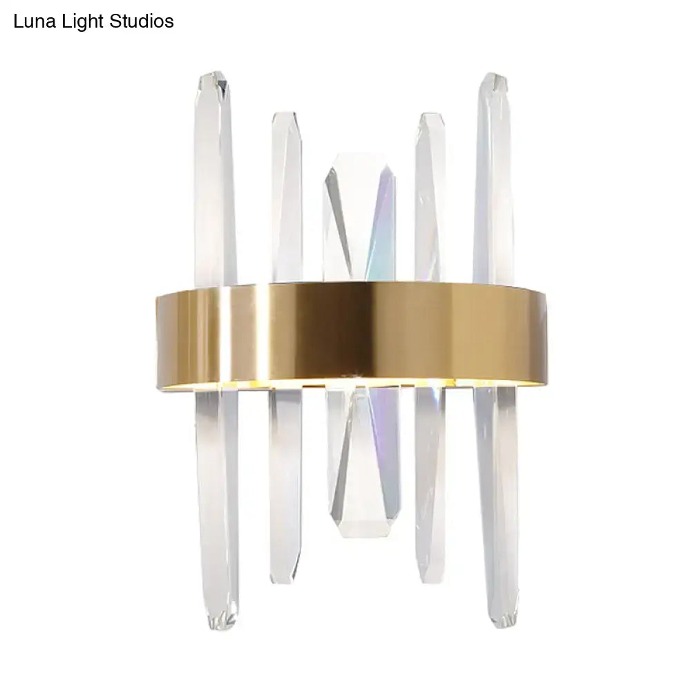 Modern gold wall sconce with clear crystal bar rods and a sleek circular base for bedroom lighting