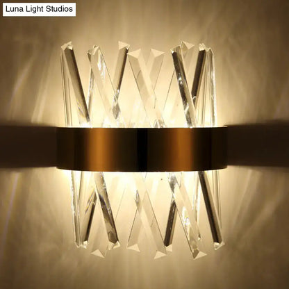 Modern gold clear crystal wall sconce with faceted prisms in x-shaped pattern and fixture height 12in for bedroom use