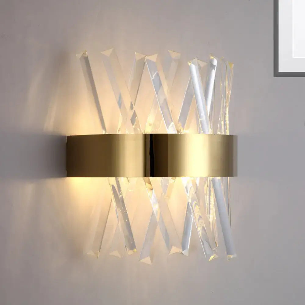 Modern gold bedroom wall sconce with clear crystal rods and a fixture height of 12in in an angular geometric design