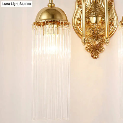 Modern gold clear crystal wall sconce with metal gooseneck arm featuring a domed top and cascading glass prisms
