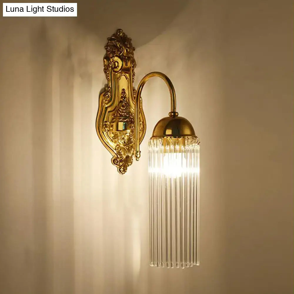 Modern gold clear crystal wall sconce with metal gooseneck arm and curved design featuring cascading prisms