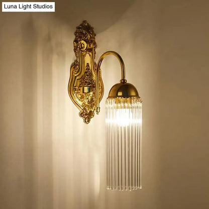 Modern gold clear crystal wall sconce with metal gooseneck arm and curved design featuring cascading prisms