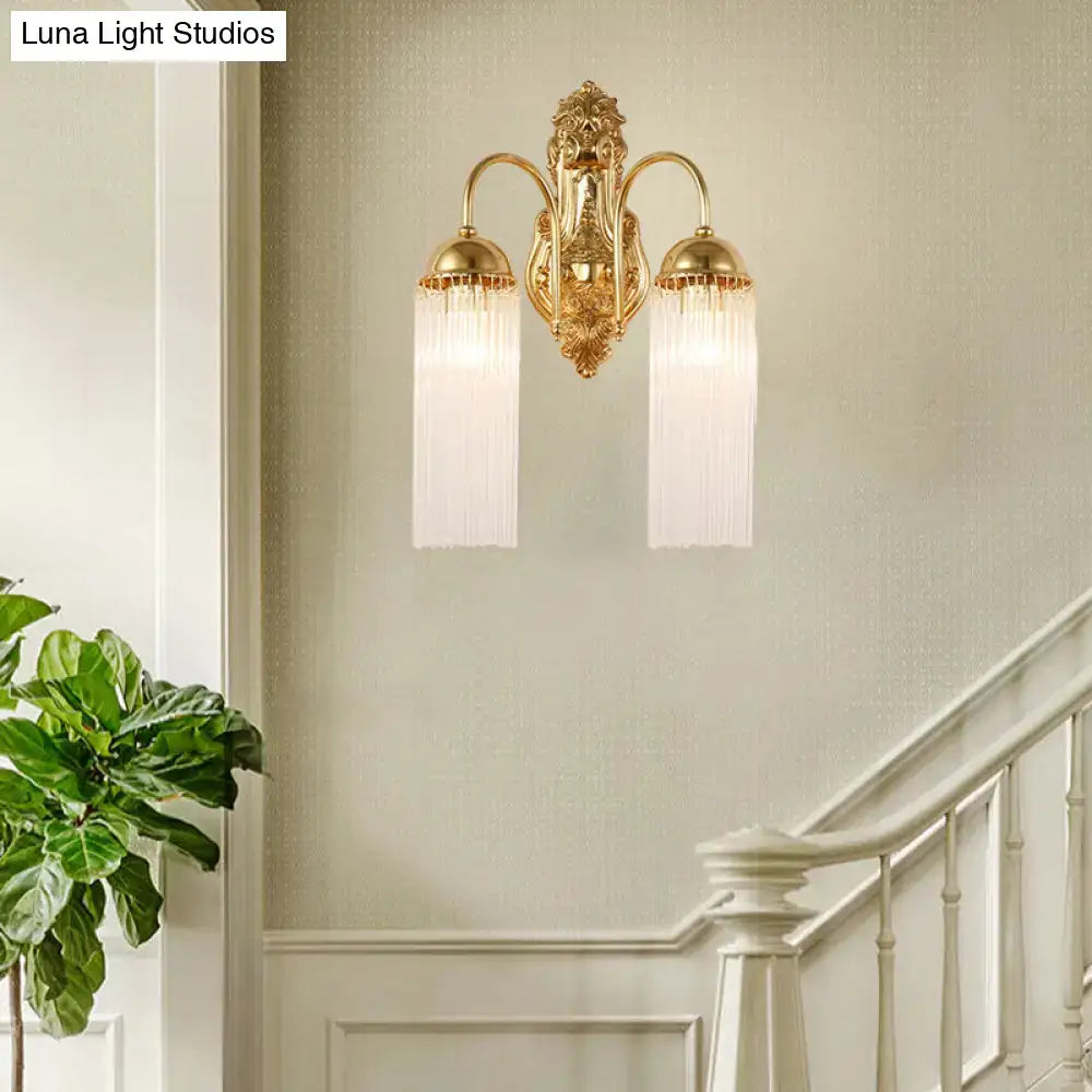 Modern gold clear crystal wall sconce with metal gooseneck arm and two frosted glass shades with vertical ridges