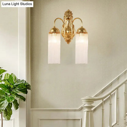 Modern gold clear crystal wall sconce with metal gooseneck arm and two frosted glass shades with vertical ridges