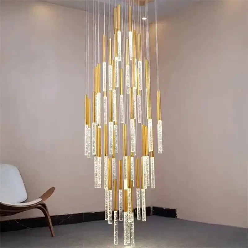 Modern gold and clear decorbites crystal led chandelier with gold metal rods and bubble-filled acrylic tubes emitting warm glow