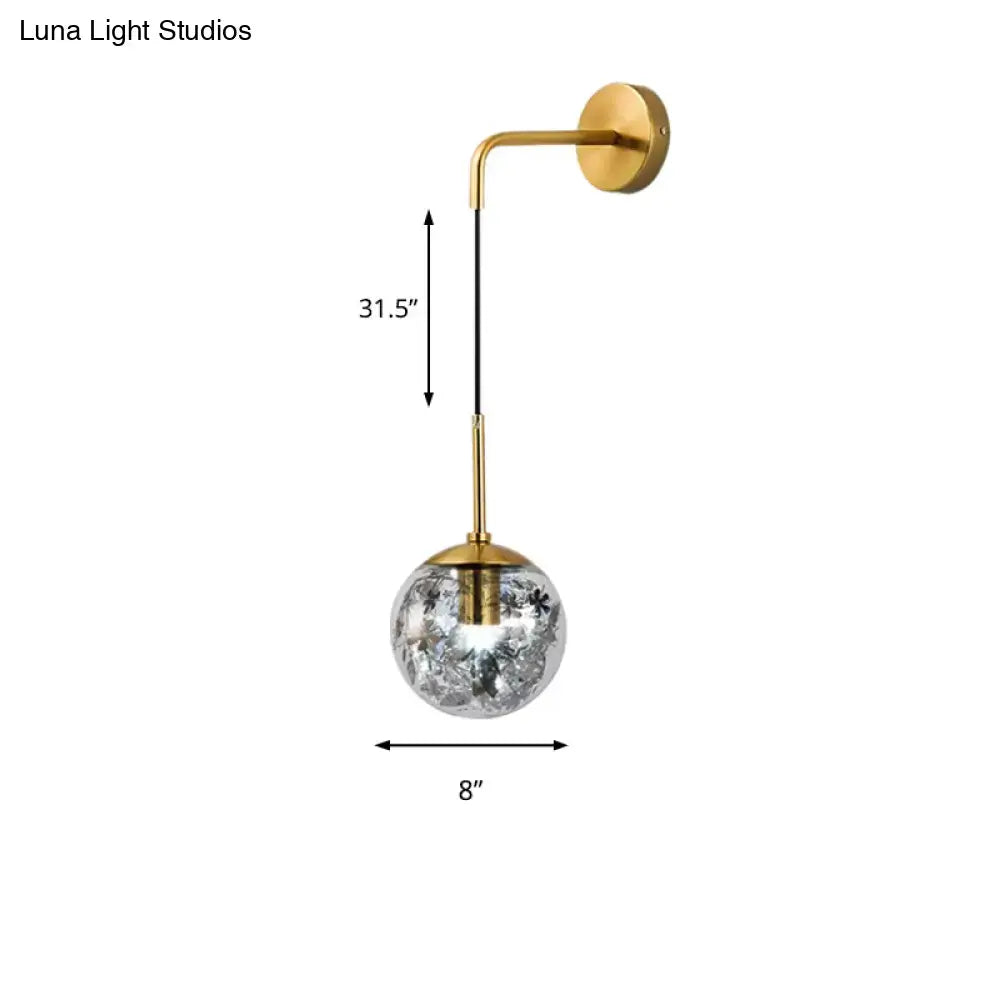 Modern gold wall light with clear glass spherical shade featuring crackled frosted texture for flower deco cloth decor