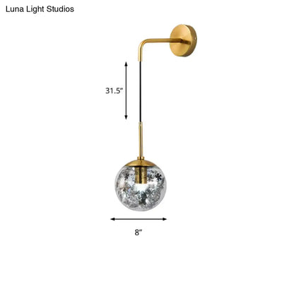 Modern gold wall light with clear glass spherical shade featuring crackled frosted texture for flower deco cloth decor