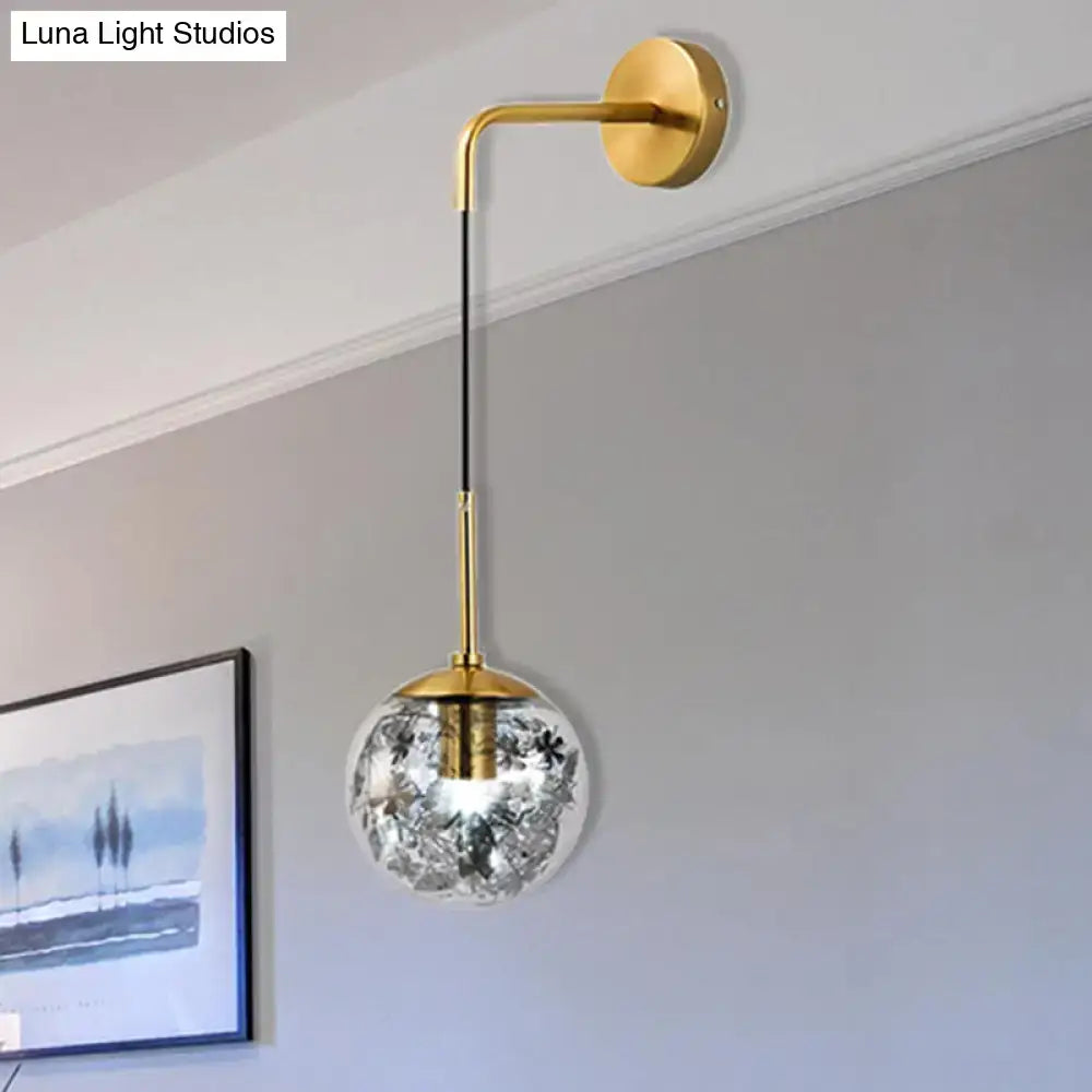 Modern gold wall light with clear glass spherical globe featuring delicate black floral etchings for flower deco cloth use
