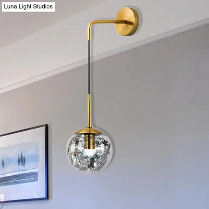 Modern gold wall light with clear glass spherical globe featuring delicate black floral etchings for flower deco cloth use