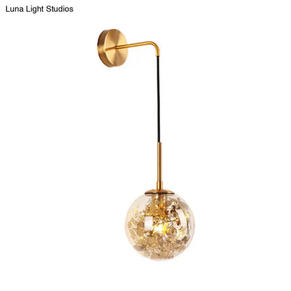 Modern gold clear glass wall light featuring a spherical globe with golden leaf fragments for flower deco cloth decor