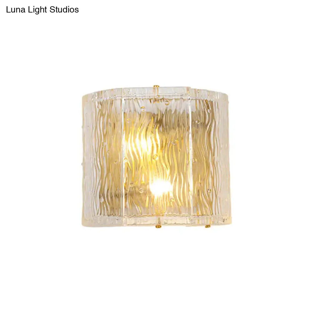 Modern gold clear ripple glass wall sconce with textured wavy pattern and gold-toned metal accents for bedroom wall light