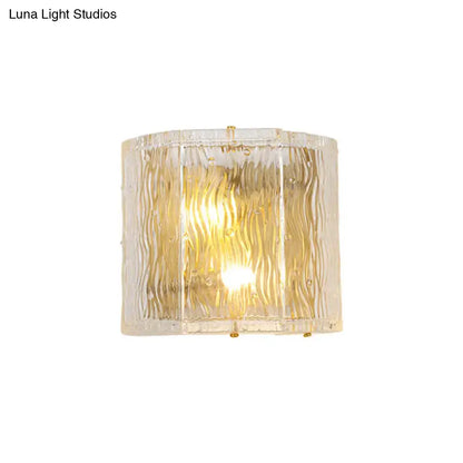 Modern gold clear ripple glass wall sconce with textured wavy pattern and gold-toned metal accents for bedroom wall light