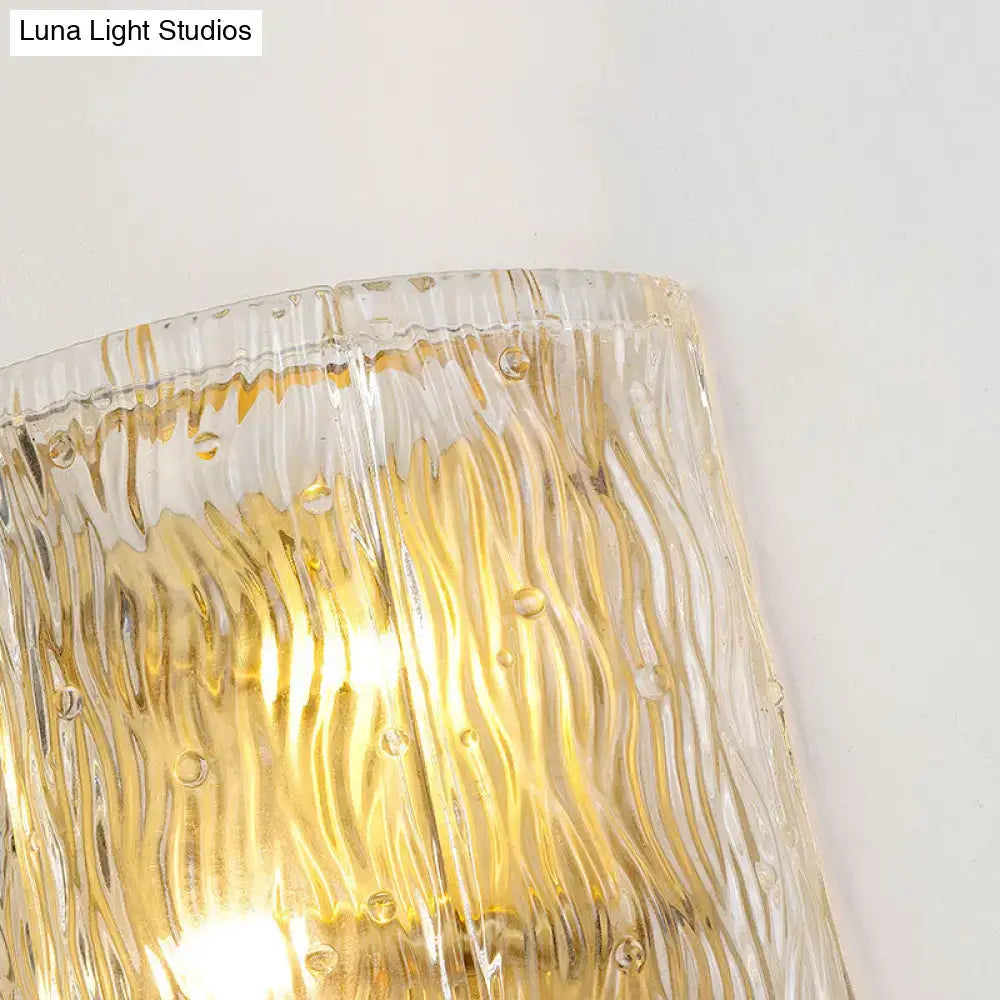 Modern gold clear ripple glass wall sconce with textured wavy ridges and embedded golden bubbles for bedroom light