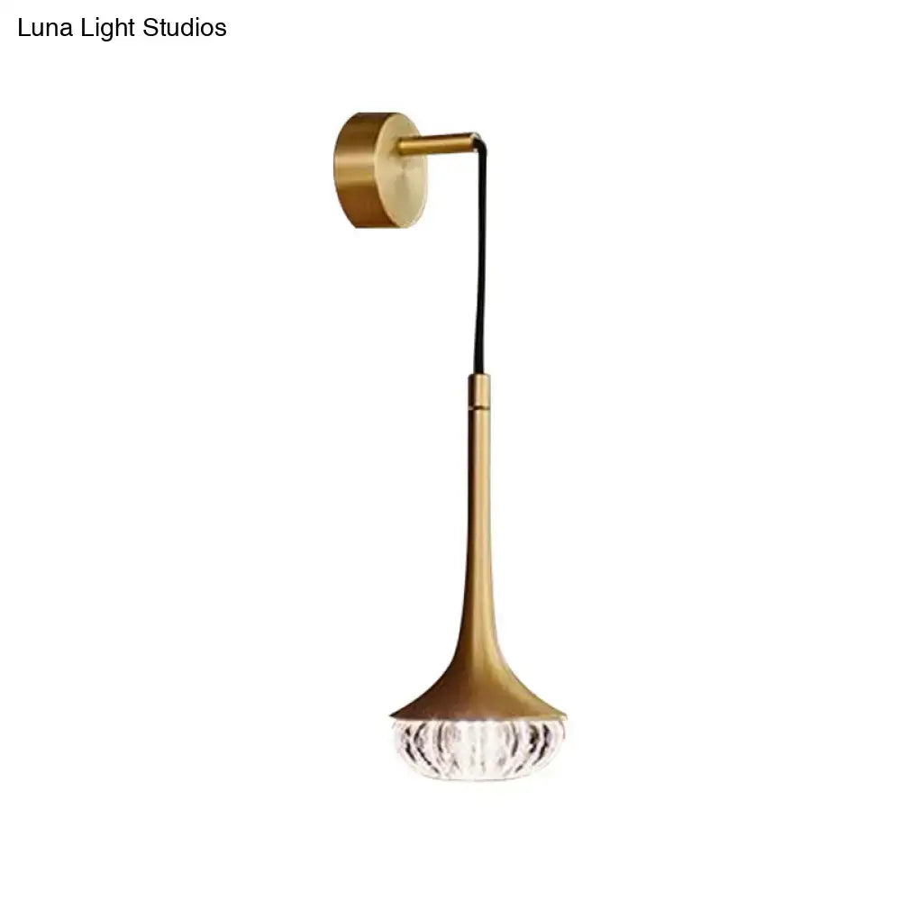 Modern gold clear textured glass wall sconce with sleek stem and faceted crystal base for living room lighting