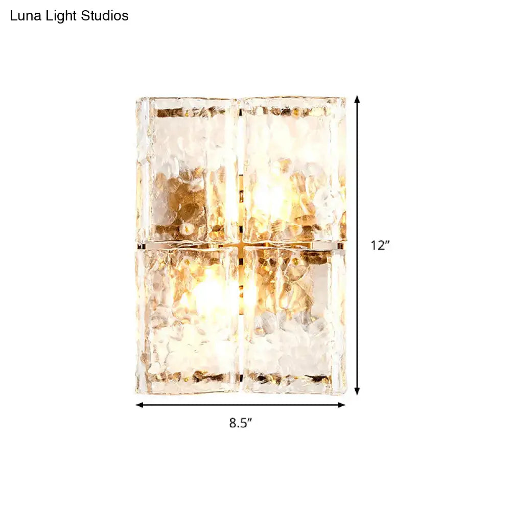 Modern gold clear water glass wall sconce with four textured frosted amber water glass shades for bedroom lighting